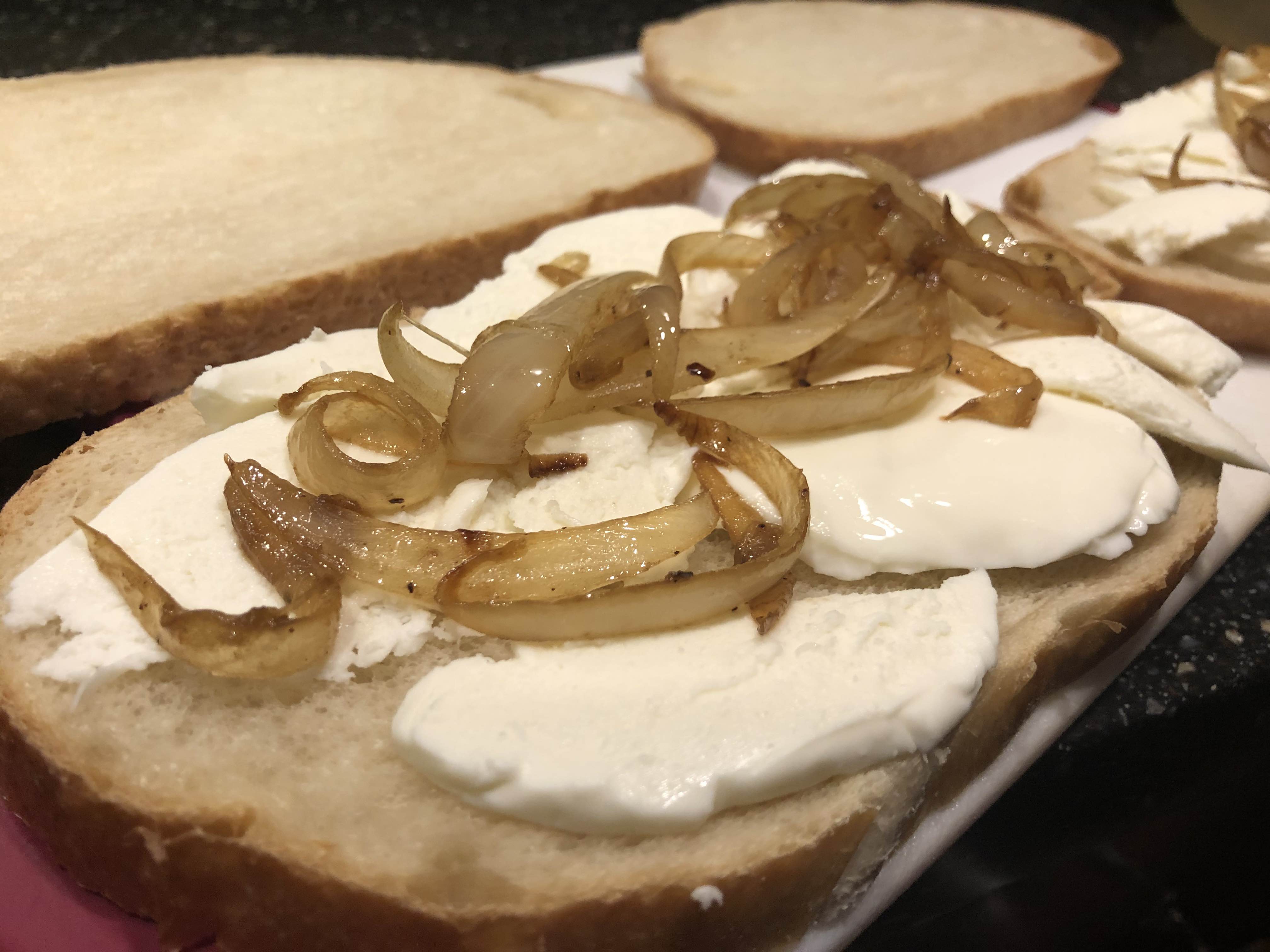 Construct, add cheese and onions to one slice of sourdough